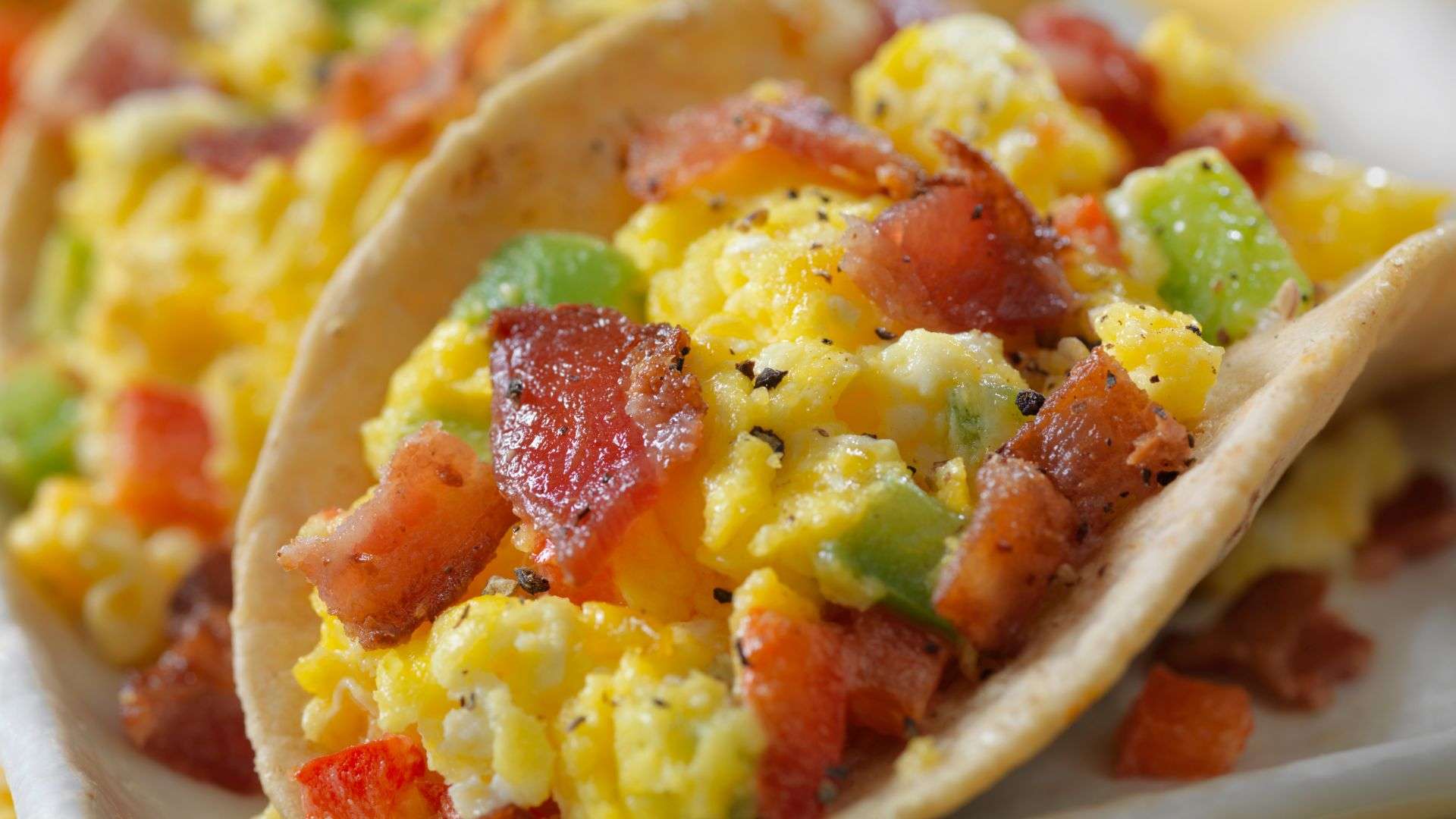 A closeup of a plate of breakfast tacos.